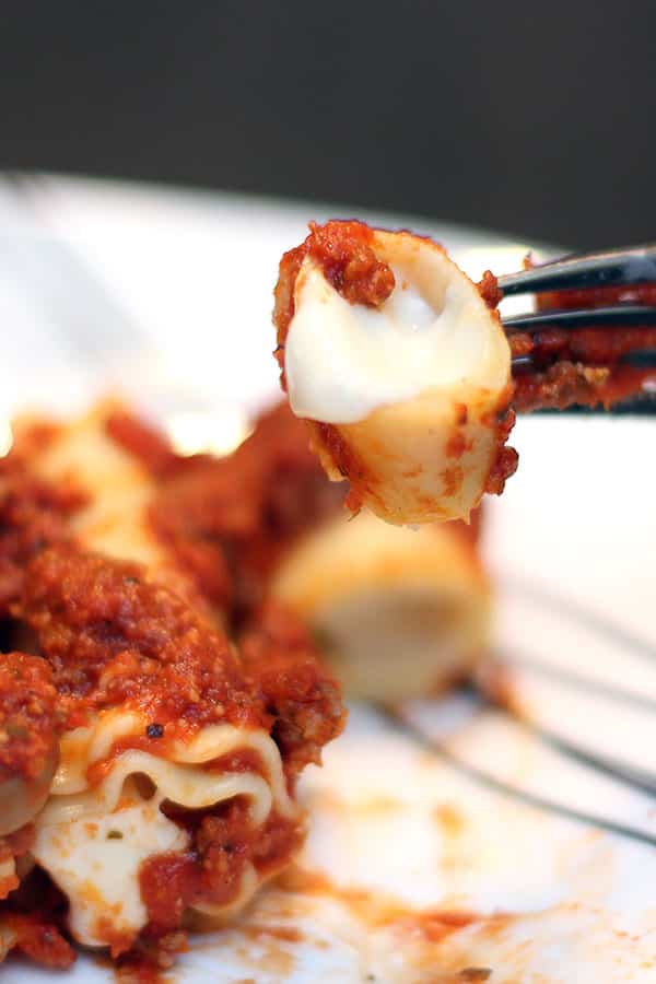 bite of baked velveeta cheese lasagna roll-up on a fork