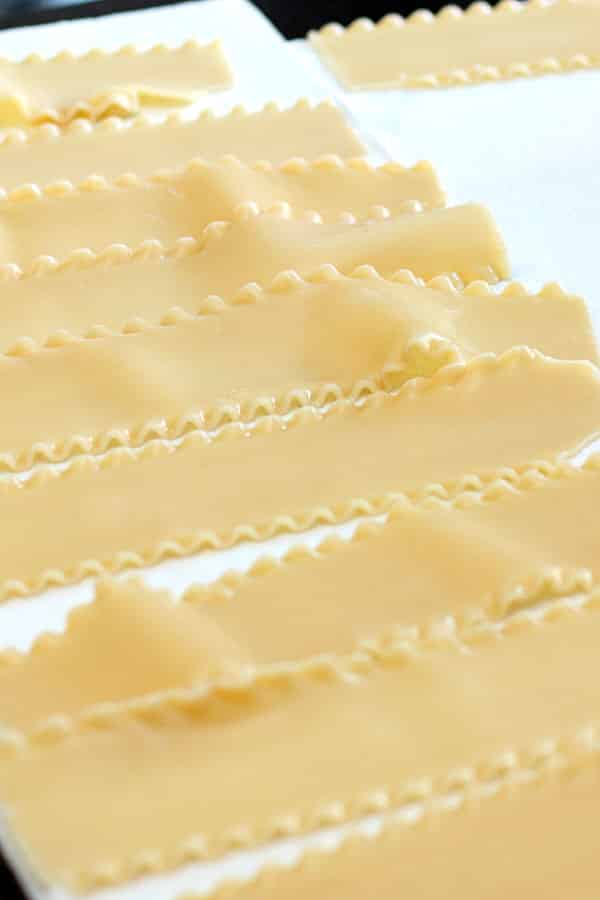 cooked lasagna noodles drying on paper towels