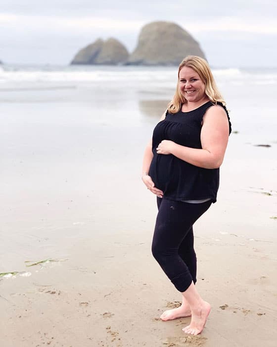 14 weeks pregnant woman showing off baby bump