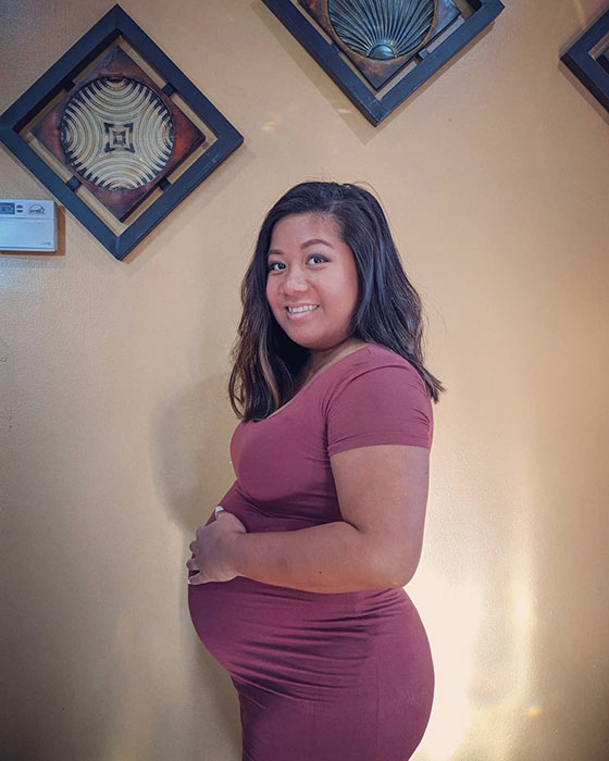 17 weeks pregnant woman showing off baby bump