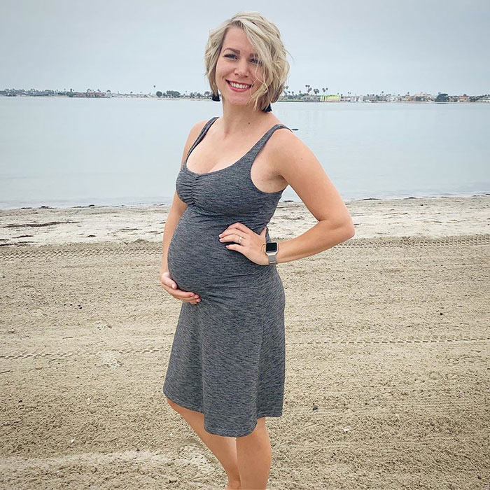 22 weeks pregnant woman showing off baby bump