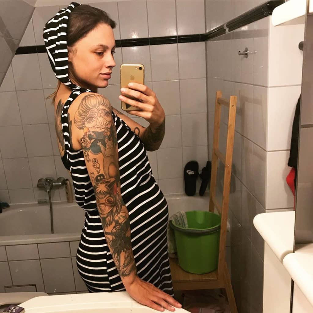 24 weeks pregnant woman showing off baby bump