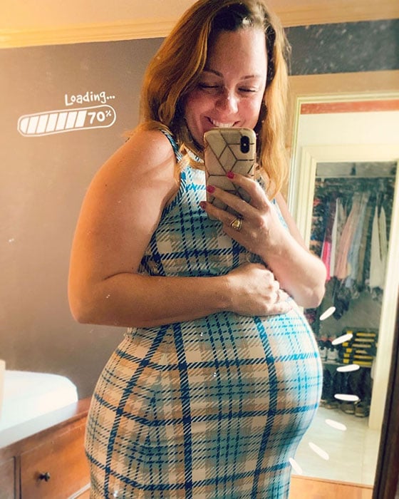 26 weeks pregnant woman showing off baby bump