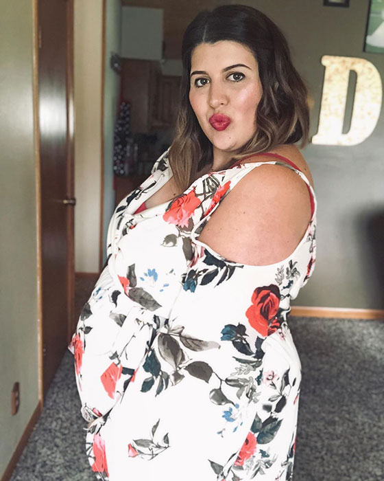 29 weeks pregnant woman showing off baby bump