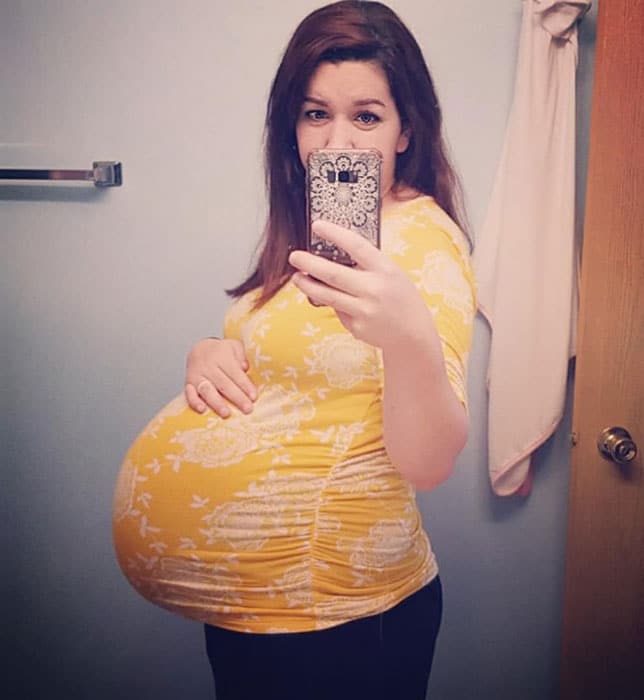 40 weeks pregnant woman showing off baby bump