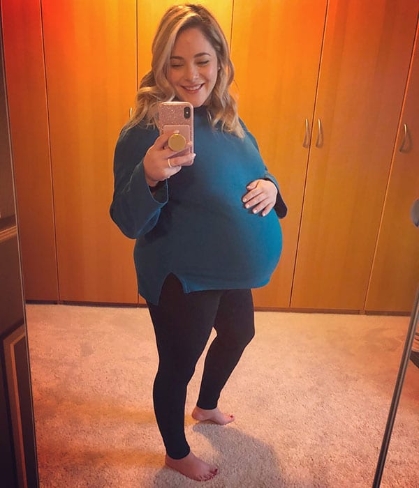 41 weeks pregnant woman showing off baby bump