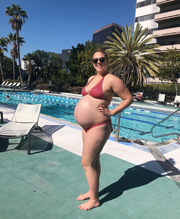 42 weeks pregnant woman showing off baby bump