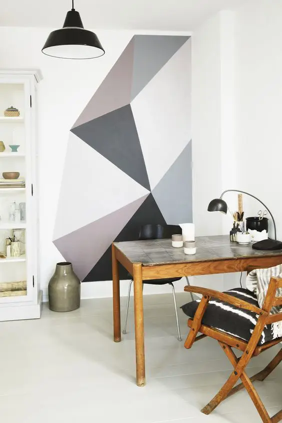 partially painted wall with funky geometric design in greys