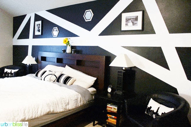 geometric black triangles with bold white stripes on a bedroom wall