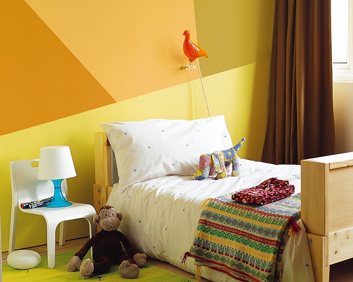 geometric design painted on yellow bedroom wall