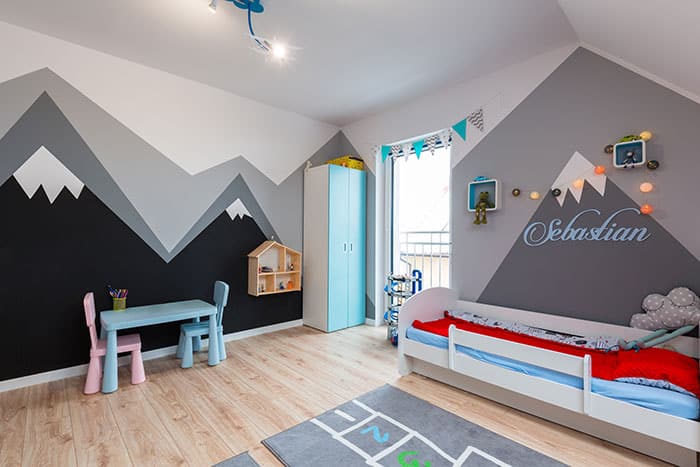 mountains painted on bedroom wall with geometric triangles