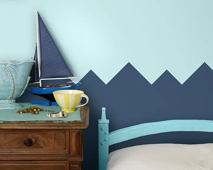 geometric wave design on bedroom wall painted with triangles