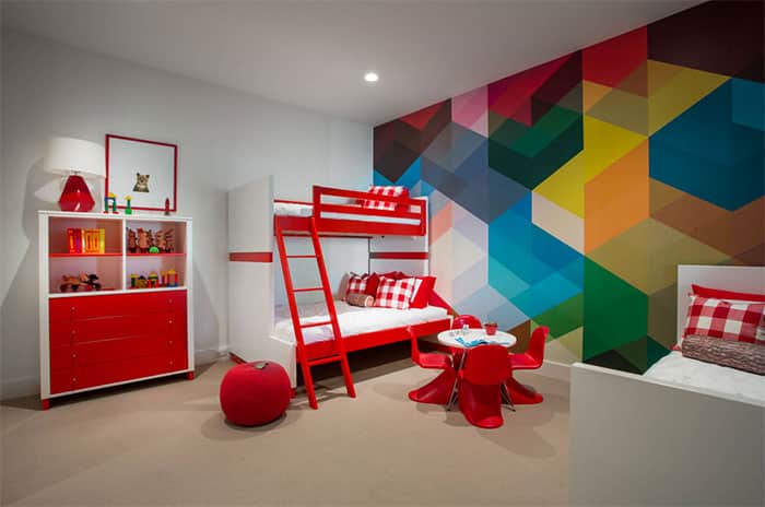 rainbow colors painted in a geometric pattern on kids bedroom wall