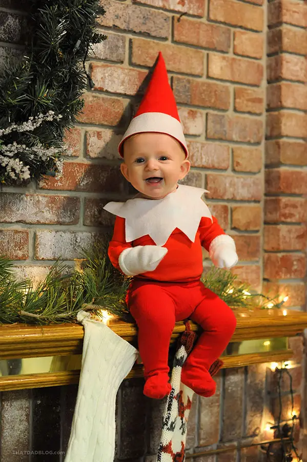 real life baby elf on the shelf sitting on the mantle