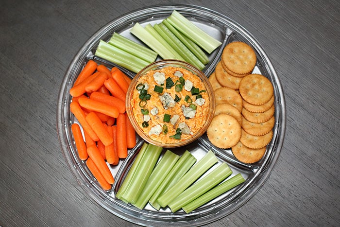 serving tray buffalo chicken dip with celery, carrots, crackers