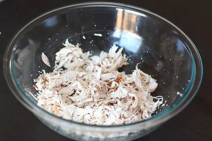 glass bowl of shredded rotisserie chicken