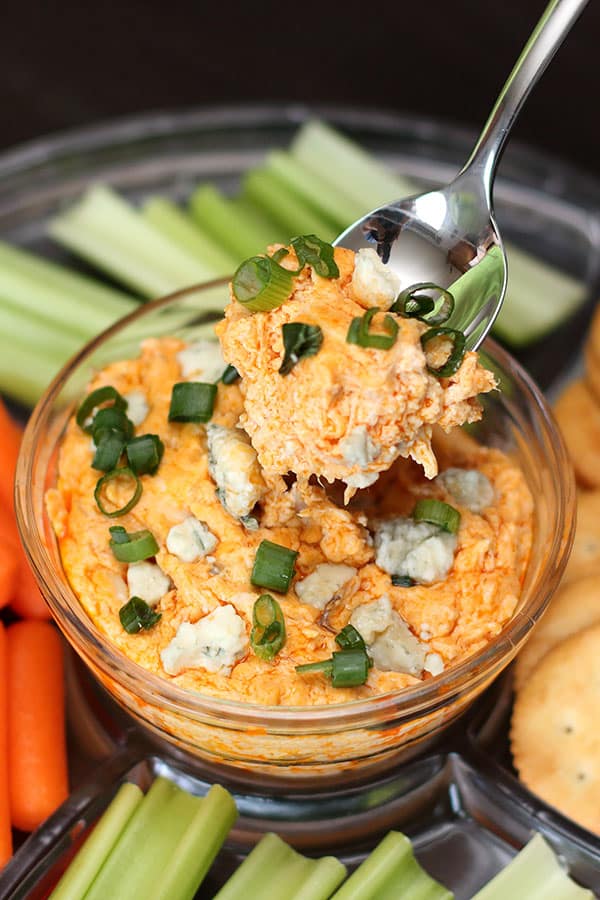 buffalo chicken dip being spooned out of platter