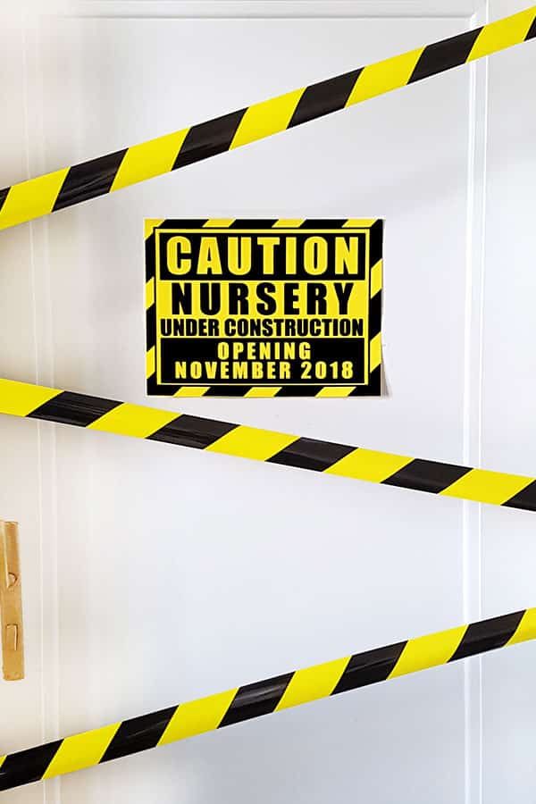 caution nursery under construction sign on door with caution tape