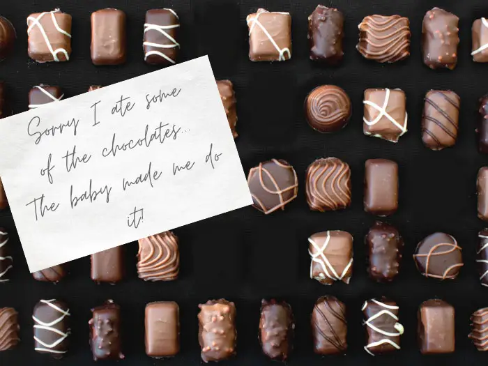 box of valentine's chocolates with some missing and a note announcing pregnancy