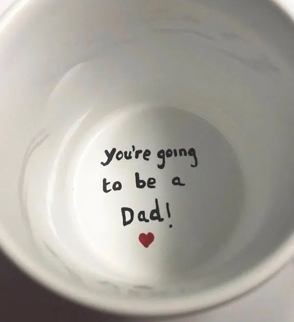 inside bottom of coffee mug announcing pregnancy