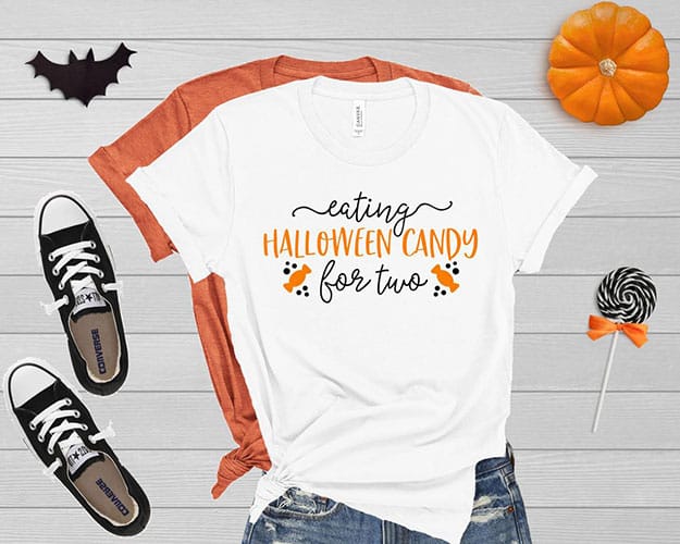 eating Halloween candy for two pregnancy announcement shirt