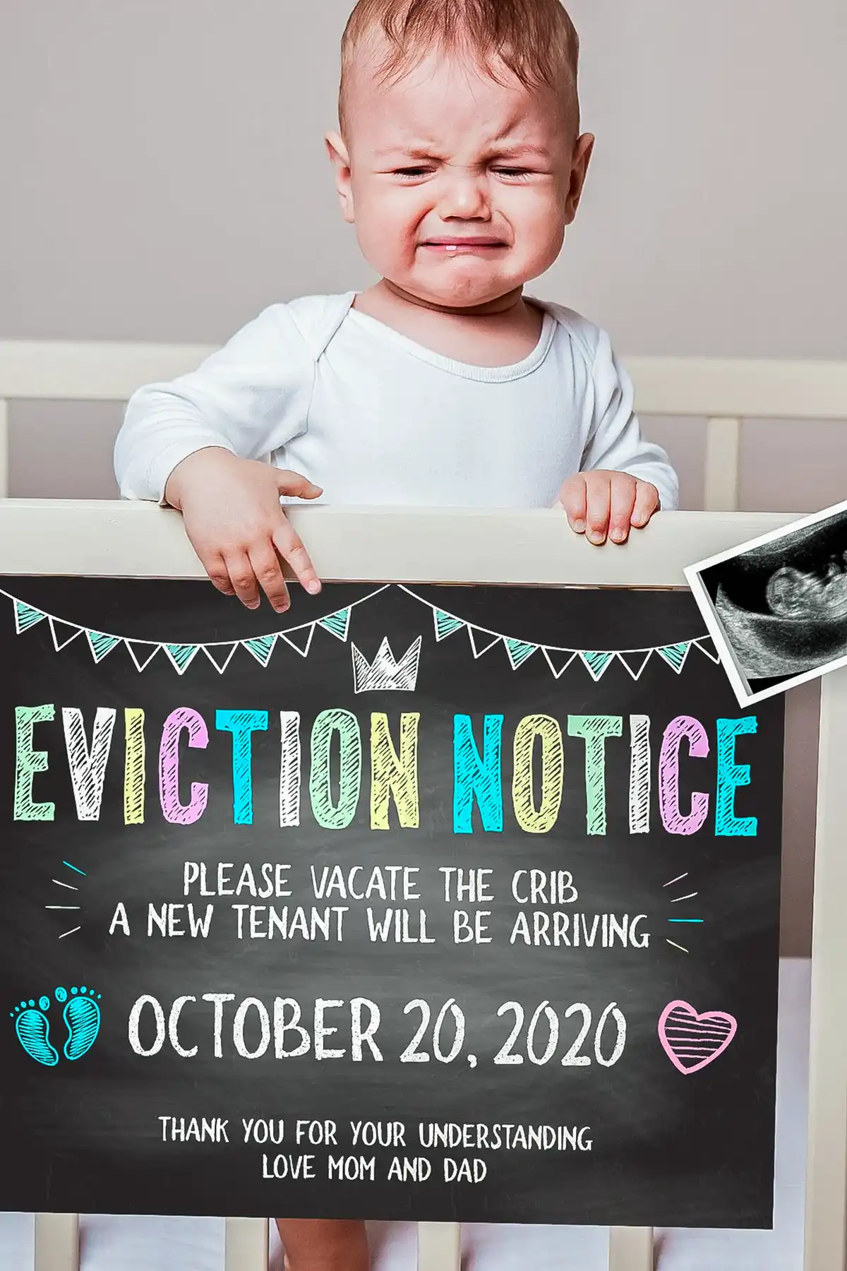 Crying baby holding a colorful eviction notice sign announcing a new sibling arriving October 20, 2020.