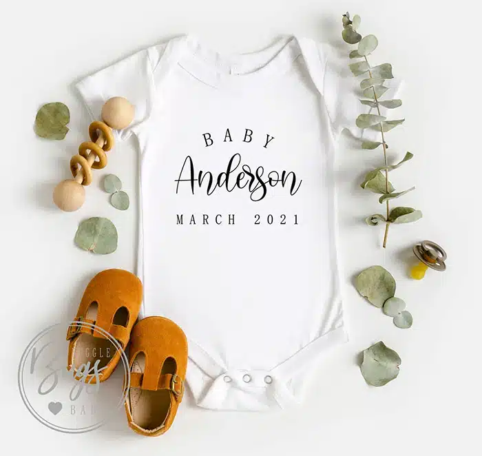 baby onesie that says "Baby Anderson March 2021"