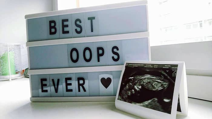 sonogram next to a lightbox sign that reads "best oops ever"