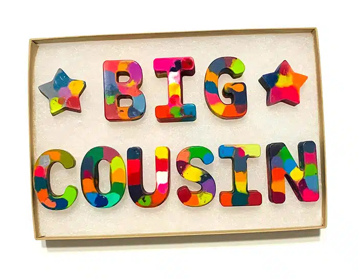 crayons melted together into letters that spell out "Big Cousin"