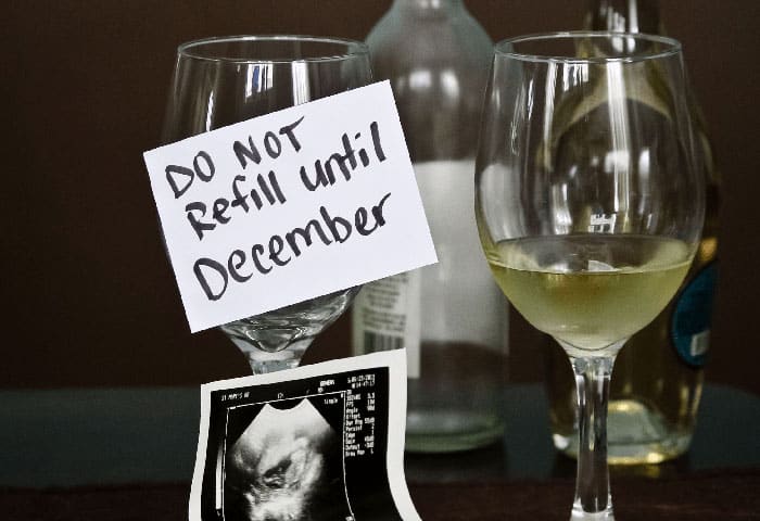 wine with a note reading "do not refill until December" above a sonogram