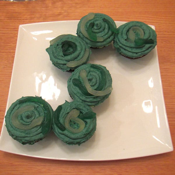green cupcakes with gummy worms as snakes for Slytherin Harry Potter cupcakes