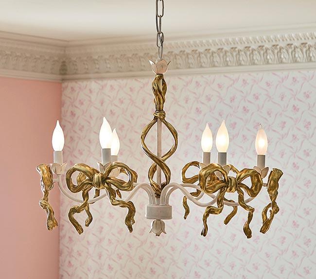 a feminine gold chandelier featuring gold bows