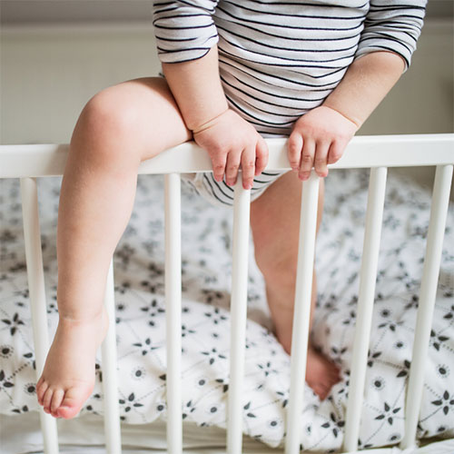 toddler climbing out of crib