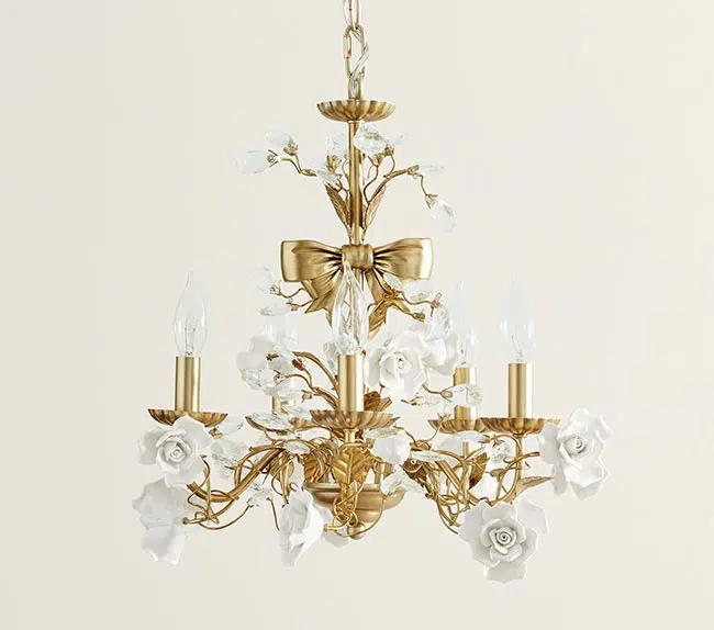 a gold chandelier with bows and white flower accents