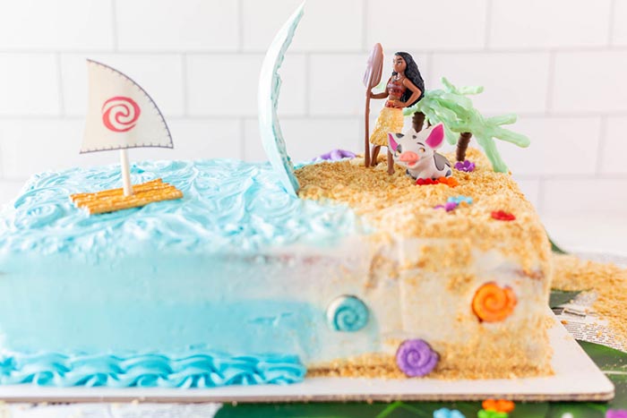 a Moana-themed birthday cake featuring the water standing up