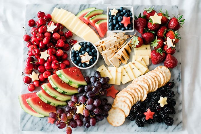 red white and blue fruit and cheese board