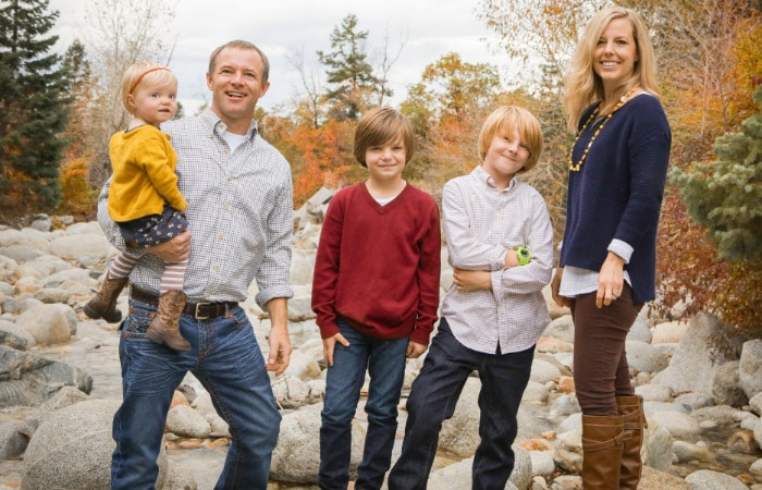 family of five standing by a creek in fall photos