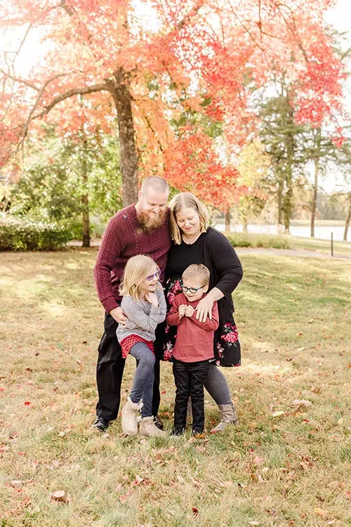 a fall family photo with everyone wearing burgundy