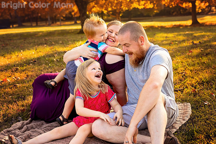 family of four with plus size mom having fun together in fall family photos