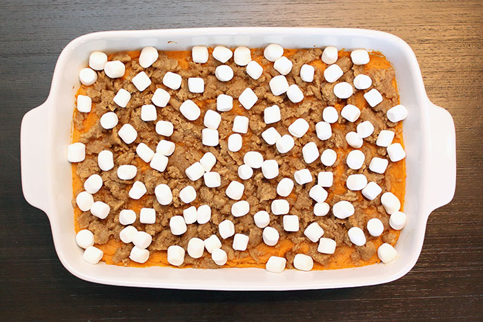 mini marshmallows on top of a sweet potato casserole with streusel