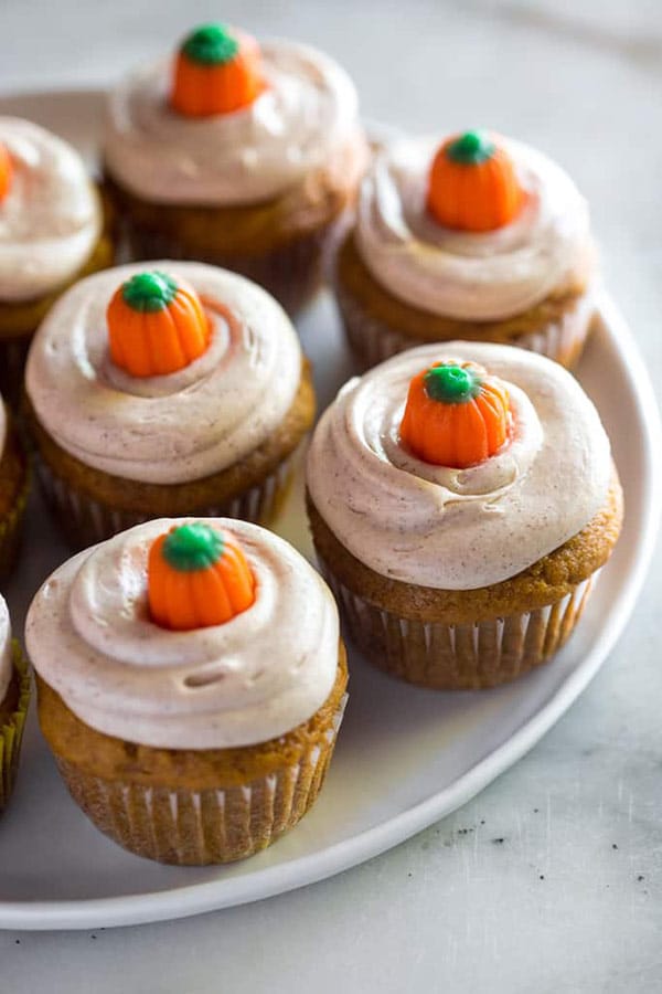 pumpkin candy corn topped pumpkin spice muffins with cinnamon cream cheese frosting