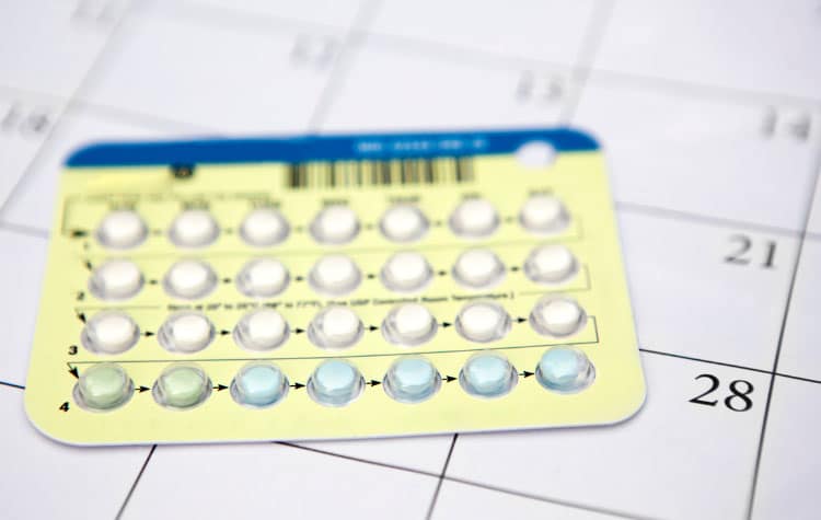 birth control with inactive or period week focused on a calendar