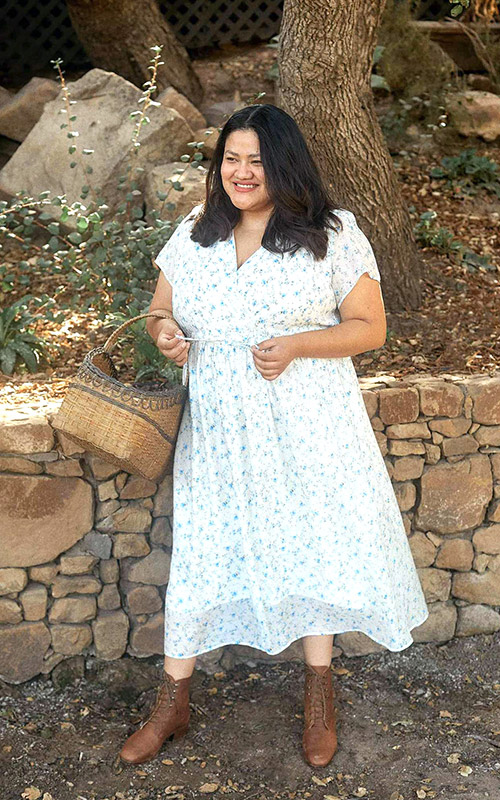 plus-size pregnant woman wearing a country-style white maternity dress