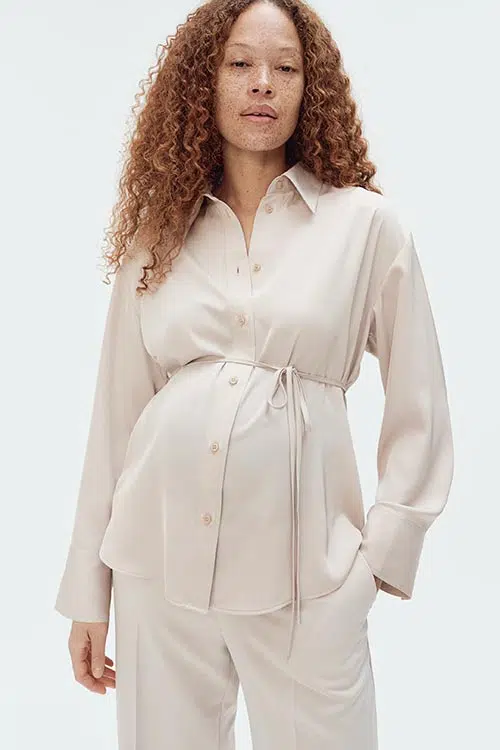 a pregnant woman wearing a tie-belt shirt