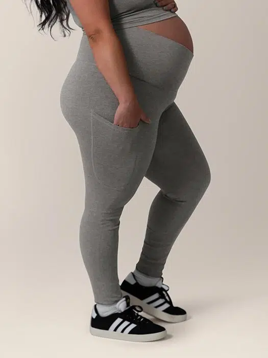 Black pregnant woman wearing charcoal leggings