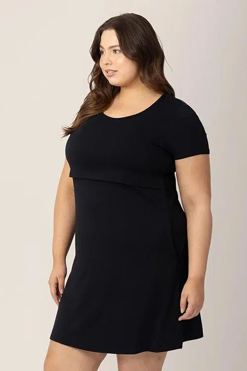 a woman wearing a black maternity dress