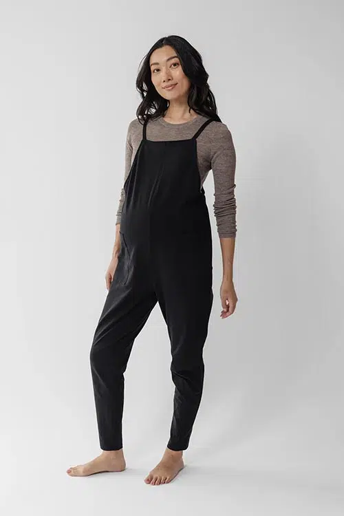 a woman wearing black maternity overalls