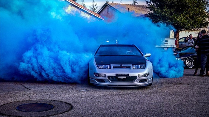 a Z32 doing a burnout to reveal blue smoke for a baby gender reveal