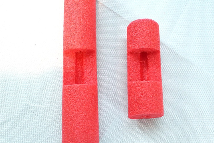 short pool noodle and long pool noodle (both red) with gouges so they can fit closely together