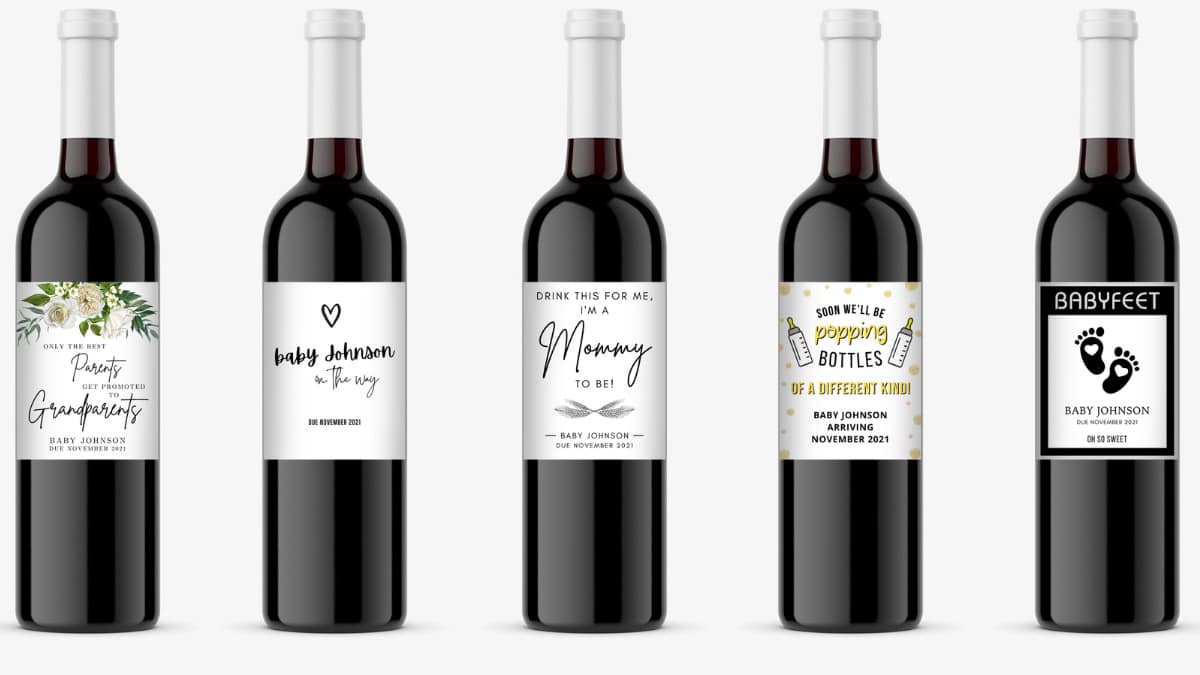 five bottles of wine with various pregnancy announcement wine labels on them